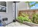 Cozy patio area with gray siding, a garden bed, and a wooden fence, creating a private outdoor space at 13844 N Cardonia Dr, Camby, IN 46113