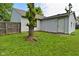 Exterior shot of the house's backyard with a lush green lawn and privacy fence at 1411 Mimosa Ct, Greenfield, IN 46140