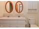 Bathroom featuring dual sink vanity, toilet, and oval mirror at 1411 Mimosa Ct, Greenfield, IN 46140
