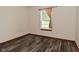 Bedroom with neutral walls, wood-look flooring, and a bright window at 1411 Mimosa Ct, Greenfield, IN 46140
