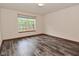 Bedroom features wood-look flooring and a light fixture, with natural light from the window at 1411 Mimosa Ct, Greenfield, IN 46140