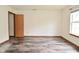 Spacious bedroom featuring new laminate wood flooring and natural light from the windows at 1411 Mimosa Ct, Greenfield, IN 46140
