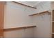 Walk-in closet featuring wooden rods and shelves for optimal storage at 1411 Mimosa Ct, Greenfield, IN 46140