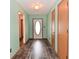 Entryway boasts modern wood-look flooring, mint-green walls, and neutral trim at 1411 Mimosa Ct, Greenfield, IN 46140