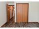 Hallway leads past closet into living areas with wood-look floors at 1411 Mimosa Ct, Greenfield, IN 46140