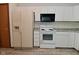 Well-equipped kitchen with white appliances and cabinets, offering plenty of storage and cooking space at 1411 Mimosa Ct, Greenfield, IN 46140