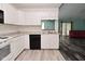 Functional kitchen with white cabinets and updated appliances, creating a clean cooking environment at 1411 Mimosa Ct, Greenfield, IN 46140