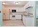 Bright kitchen with white cabinets, appliances, and ample counter space for cooking and entertaining at 1411 Mimosa Ct, Greenfield, IN 46140