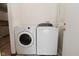 Laundry area featuring a front-loading washer and traditional dryer at 1411 Mimosa Ct, Greenfield, IN 46140