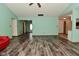 Spacious living room featuring wood-look floors and light-colored walls, seamlessly flowing into other areas of the home at 1411 Mimosa Ct, Greenfield, IN 46140