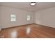 Bright living room featuring wood floors, neutral paint, and large windows at 1411 Mimosa Ct, Greenfield, IN 46140