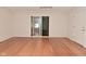 Bright living room featuring wood floors, neutral paint, and sliding glass doors at 1411 Mimosa Ct, Greenfield, IN 46140