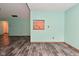 Open-concept living area with wood-look floors and a kitchen pass-through, creating a seamless flow at 1411 Mimosa Ct, Greenfield, IN 46140