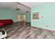 Expansive living room with wood-look floors and an open layout, providing a versatile space for living at 1411 Mimosa Ct, Greenfield, IN 46140