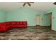 Living room features modern floors, light green walls, red sofa and ample space at 1411 Mimosa Ct, Greenfield, IN 46140