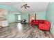 Spacious living room with modern wood-look floors, mint-green walls, and neutral trim at 1411 Mimosa Ct, Greenfield, IN 46140