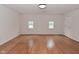 Bright living room featuring wood floors, neutral paint, and large windows at 1411 Mimosa Ct, Greenfield, IN 46140