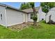 A serene patio area for relaxation next to siding on a home with green grass at 1411 Mimosa Ct, Greenfield, IN 46140