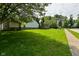 A spacious, green backyard features a partial fence and a view of the house at 1411 Mimosa Ct, Greenfield, IN 46140