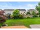 The backyard features a well-maintained lawn, privacy fence, and mature trees, creating a private outdoor space at 14446 Chapelwood Ln, Fishers, IN 46037