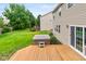View of the backyard featuring a deck with a hot tub and a well-maintained lawn, perfect for relaxation and outdoor fun at 14446 Chapelwood Ln, Fishers, IN 46037