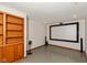 Finished basement with a large screen and built-in shelving at 14446 Chapelwood Ln, Fishers, IN 46037