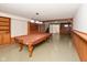 Finished basement features a pool table, exposed brick, and built-in shelving at 14446 Chapelwood Ln, Fishers, IN 46037