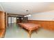 Finished basement features a pool table, exposed brick, and wood accents at 14446 Chapelwood Ln, Fishers, IN 46037