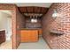 Finished basement featuring a wet bar area with brick accents and wood trim at 14446 Chapelwood Ln, Fishers, IN 46037