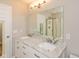 Double sink vanity with marble countertop and a large mirror with lighting at 14446 Chapelwood Ln, Fishers, IN 46037