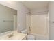 Neutral bathroom with a single sink vanity, large mirror, and shower-tub combo with a shower curtain rod at 14446 Chapelwood Ln, Fishers, IN 46037