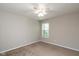 Bedroom with a window allowing natural light, a ceiling fan, neutral paint, and carpet flooring at 14446 Chapelwood Ln, Fishers, IN 46037