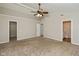 A large carpeted bedroom with three doorways and a vaulted ceiling at 14446 Chapelwood Ln, Fishers, IN 46037