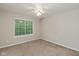 A cozy bedroom with neutral carpet and a window offering ample natural light at 14446 Chapelwood Ln, Fishers, IN 46037