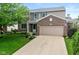 Charming two-story home with a well-manicured lawn, brick accents and attached two-car garage at 14446 Chapelwood Ln, Fishers, IN 46037