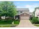 Charming two-story home with a well-manicured lawn, brick accents and attached two-car garage at 14446 Chapelwood Ln, Fishers, IN 46037