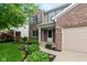 Charming two-story home with a well-manicured lawn, brick accents and attached two-car garage at 14446 Chapelwood Ln, Fishers, IN 46037