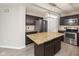 Modern kitchen features stainless steel appliances, dark cabinets, granite countertops, and a kitchen island at 14446 Chapelwood Ln, Fishers, IN 46037