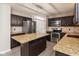 Modern kitchen features stainless steel appliances, dark cabinets, granite countertops, and a kitchen island at 14446 Chapelwood Ln, Fishers, IN 46037