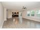 Bright and airy living room features hardwood floors, ceiling fan, and sliding door to backyard at 14446 Chapelwood Ln, Fishers, IN 46037