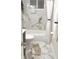 Bright bathroom features modern gold fixtures, tiled walls, and a shower with a curtain at 1513 S Rural St, Indianapolis, IN 46203