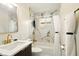 A renovated bathroom with a modern vanity, gold fixtures and tiled shower at 1513 S Rural St, Indianapolis, IN 46203
