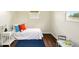 A bedroom with a twin bed, blue carpet, and an accent wall at 1513 S Rural St, Indianapolis, IN 46203