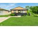 Charming single Gathering home with manicured lawn, neutral paint scheme and welcome wreath on the front door at 1513 S Rural St, Indianapolis, IN 46203
