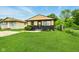 Charming single Gathering home with manicured lawn, neutral paint scheme and welcome wreath on the front door at 1513 S Rural St, Indianapolis, IN 46203