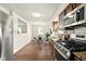 Eat-in kitchen features stainless steel appliances, granite countertops, and a view into the adjacent dining area at 1513 S Rural St, Indianapolis, IN 46203