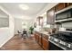 Renovated kitchen open to dining area, showcasing updated appliances, granite counters, and stylish backsplash tiles at 1513 S Rural St, Indianapolis, IN 46203