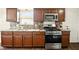 Modern kitchen featuring stainless steel appliances, granite countertops, and dark wood cabinets offering ample storage space at 1513 S Rural St, Indianapolis, IN 46203