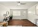 Bright living room with wood floors, a ceiling fan, and neutral decor at 1513 S Rural St, Indianapolis, IN 46203