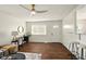 Open-concept living area complete with hardwood floors, ceiling fan, and convenient breakfast bar seating at 1513 S Rural St, Indianapolis, IN 46203